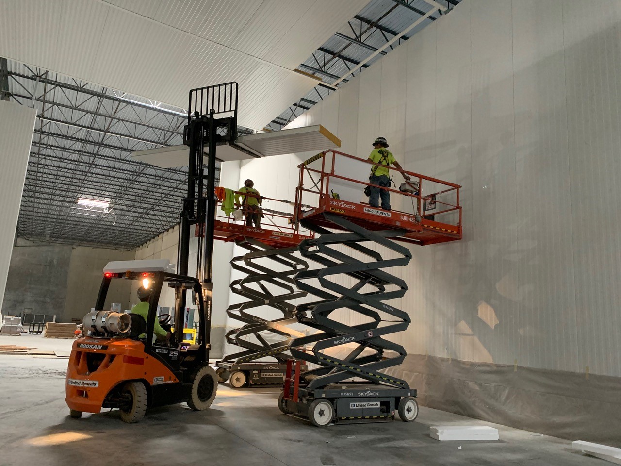 Installing a suspended insulated metal panel (IMP) ceiling