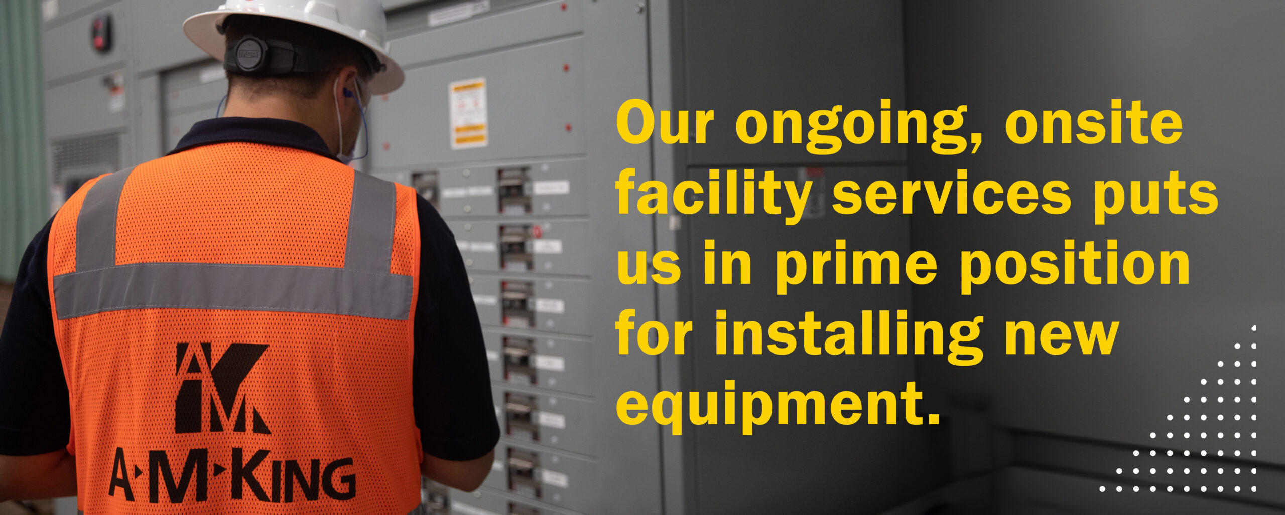 An A M King expert wearing an orange vest, performing ongoing, onsite facility services.